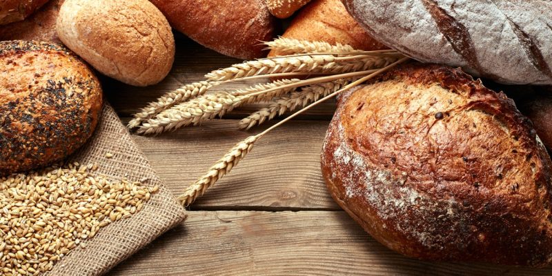 heap of bread heap of various kind of bread on wooden background